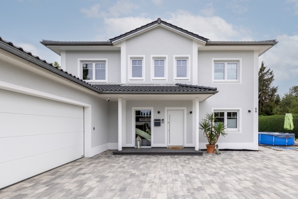 Der Eingangsbereich überzeugt durch eine klare Struktur bei diesem modernen Einfamilienhaus im Toskana-Stil. Schlüsselfertig von Ottillinger Bau GmbH.